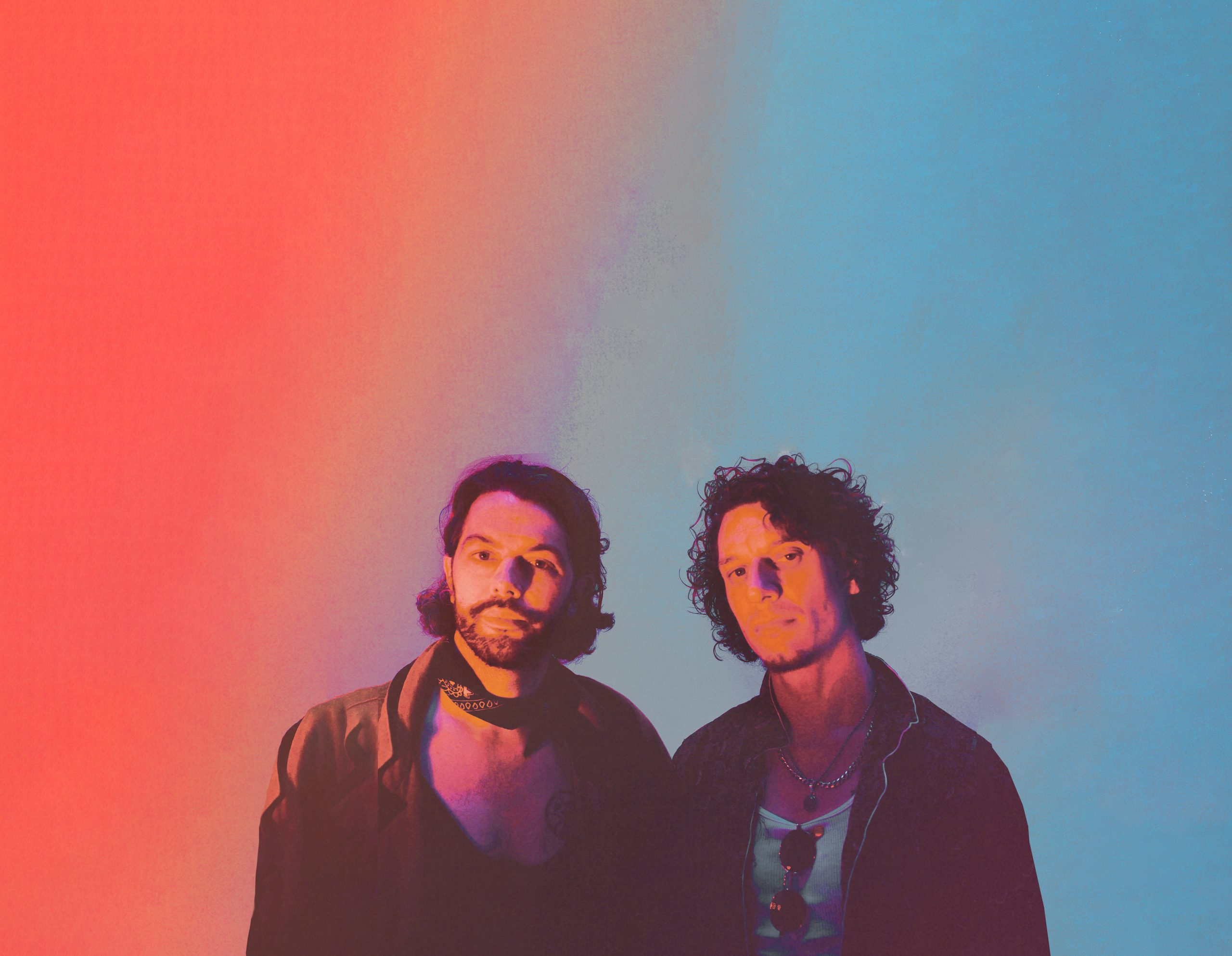 The duo standing against a sunset wash of orange and blue — the Never Ending Sunset cover art without its lettering
